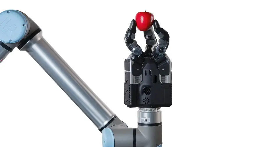 Robot hand holding a red apple