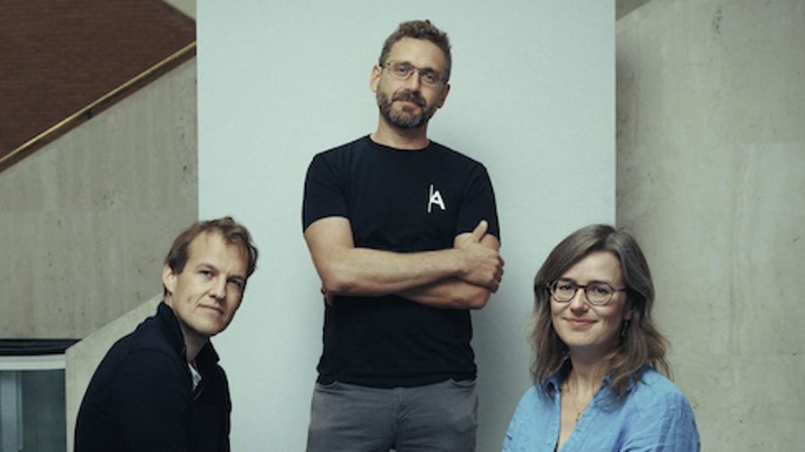 A photo of Matt Clifford, Ilan Gur and Angie Burnett looking at the camera. Matt and Angie are sat down and Ilan is standing.