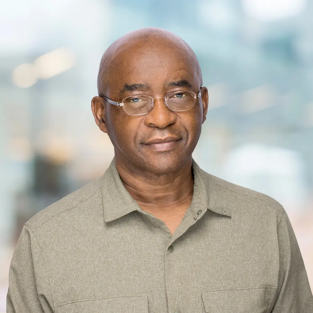 Headshot of Strive Masiwiya against a blurred background