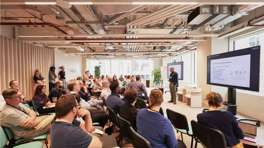 A group of people attending a talk hosted by ARIA