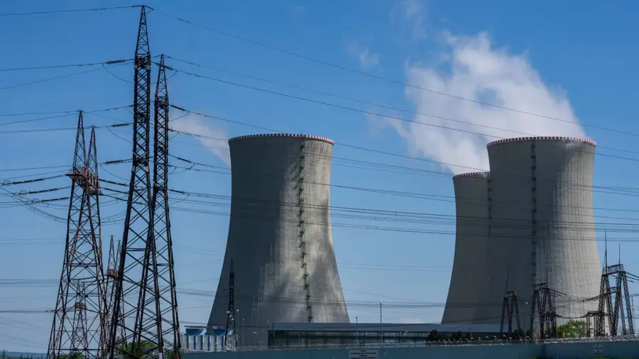 Nuclear power plant with cooling towers and transmission lines
