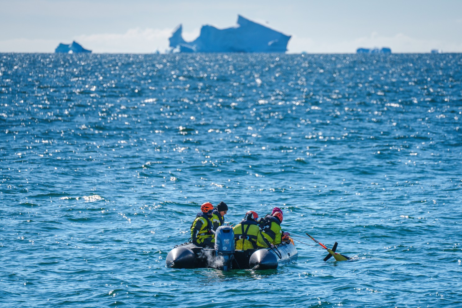 A team of scientists and crew members deploy an underwater glider in Antarctica.