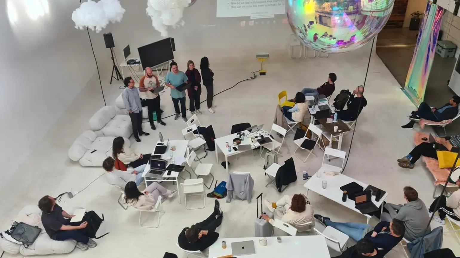 Birds eye view of a room of people in discussion at ARIA's Innovator Circle pilot